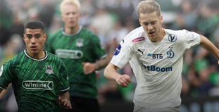 Изображение показывает двух футболистов на поле: один в зелёной форме с логотипом Winline, другой в белой форме с логотипом VTB. Они сосредоточены на игре, вокруг виден размытый фон стадиона